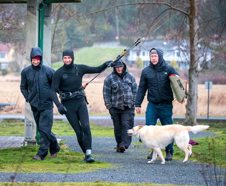 This photo, to the keen observer, has 3 things that indicate how windy it was today. 1. The Posse. Erik walked his 3M to the water with an entourage waiting for the slightest hint of sh$t hitting the fan. 2. Look at Erik's eyes. Kid in candy store at Christmas-type eyes. 3. The dog's hind legs are blowing up off the ground and his tail indicates 43 gusting 52 ðŸ˜‚
