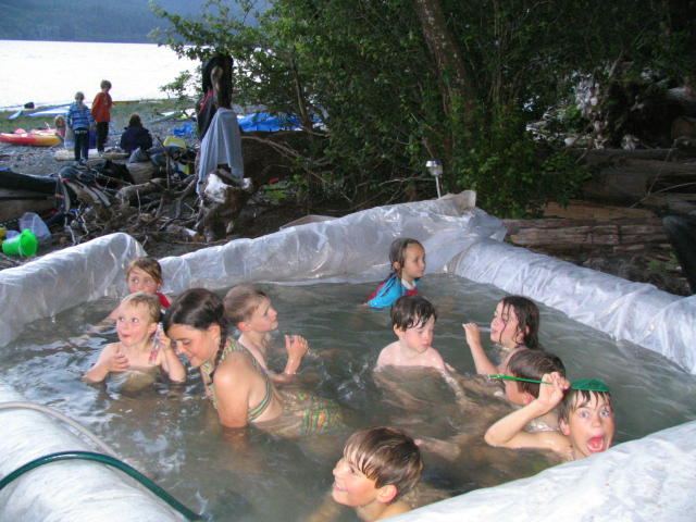 Nitnat Hot Tub
What do you get when you mix rainy weather, bored windsurfers and bored kiteboards with time on their hands at Nitinat?  A HOT TUB!  That's right, a feat of scientific genius created an actual HOT tub (too hot at times) on the beach at Nitinat - they had a pump pumping water out of the tub into 70 feet of coiled copper coil that was in the fire with water heating up through the coil they routing back into the tub!  The pump was run by a generator and the tub was made by digging out sand in the middle (to act as a bench for the feet) and cutting logs up to place around with a tarp in the centre - voila!  Sure felt good after a long day sailing..........

